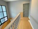 A bright hallway with wooden floor and a window