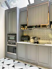 Modern kitchen with grey cabinets and stainless steel appliances