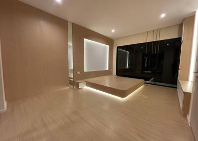 Modern minimalistic living room with wooden flooring and recessed lighting