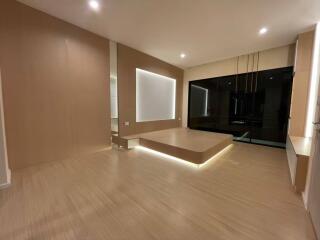 Modern minimalistic living room with wooden flooring and recessed lighting