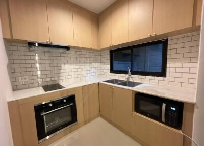 Modern kitchen with wooden cabinets and white subway tile backsplash