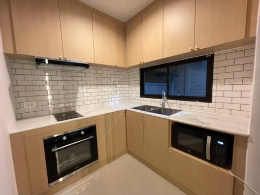 Modern kitchen with wooden cabinets and white subway tile backsplash