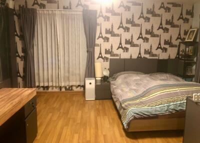 Well-furnished bedroom with a double bed and wooden flooring