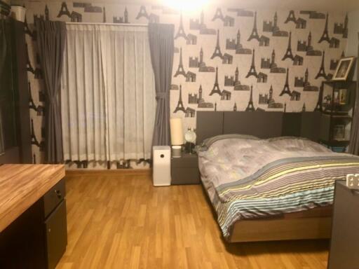 Well-furnished bedroom with a double bed and wooden flooring