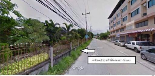 Street view of residential area with apartment building and greenery