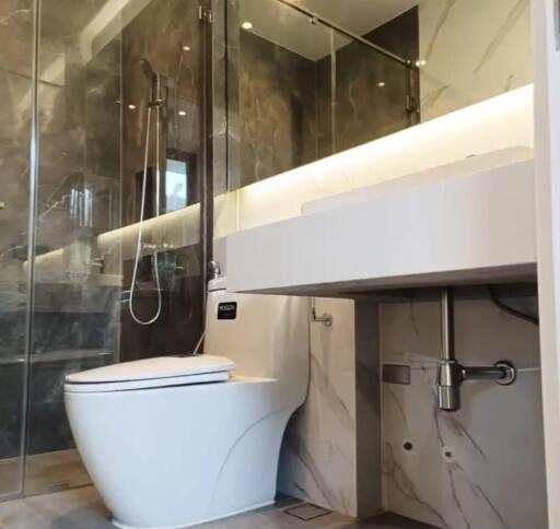 Modern bathroom with glass shower and white fixtures