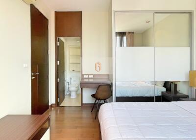 Spacious bedroom with attached bathroom and modern furniture
