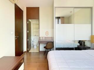 Spacious bedroom with attached bathroom and modern furniture