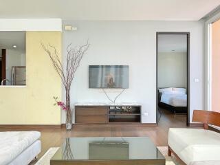 Modern living room with TV and adjacent bedroom