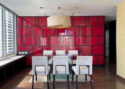 Modern dining room with glass table and six upholstered chairs