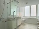 Modern bathroom with large window, bathtub, and glass shower