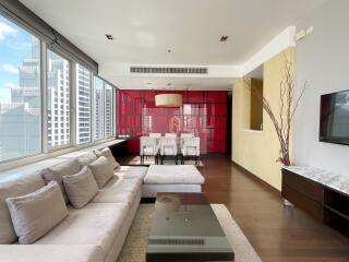 Modern living room with large windows and city view