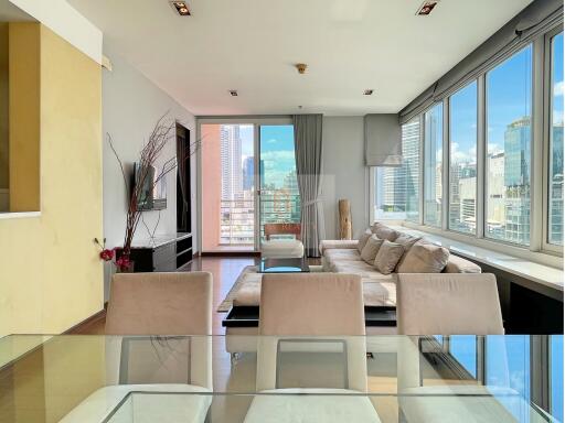 Spacious living room with large windows and city view