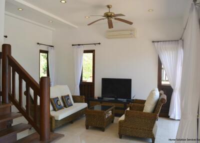 Living room with seating area and TV