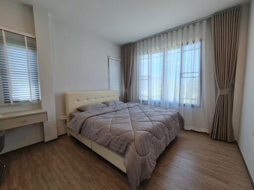 Modern bedroom with large bed and natural light