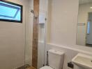 Modern bathroom with walk-in shower and neutral tiles