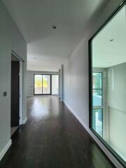 Modern hallway with wooden flooring and large windows