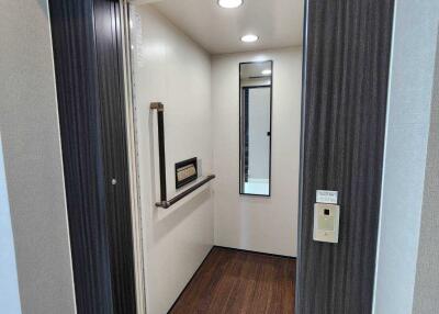 Apartment elevator interior with wooden flooring and mirror