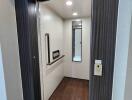 Apartment elevator interior with wooden flooring and mirror