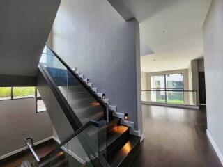 Modern interior with staircase and large windows