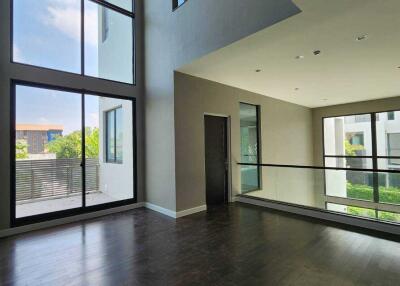 Spacious living room with large windows and natural lighting