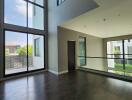 Spacious living room with large windows and natural lighting