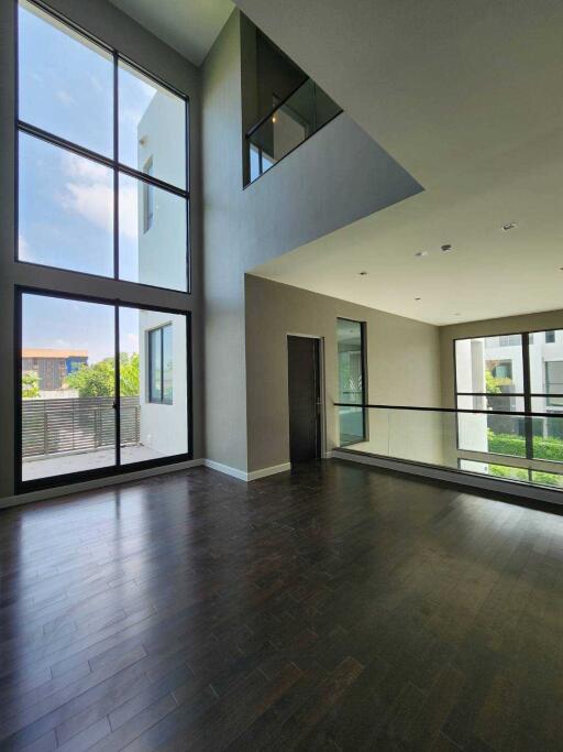 Spacious living room with large windows and natural lighting