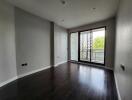 Spacious empty living room with dark hardwood floors