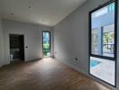 Modern living room with large windows and wood flooring