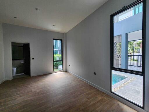 Modern living room with large windows and wood flooring