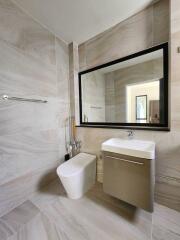 Modern bathroom with large mirror and sleek fixtures