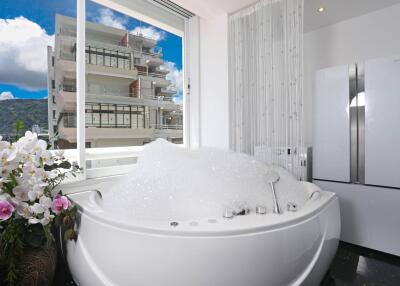 Modern bathroom with a jacuzzi and large window view