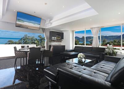 Modern living room with ocean view and black leather furniture
