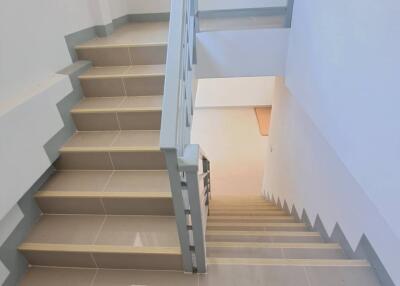 Modern staircase with tiled steps and railing