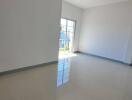 Bright and empty living room with tiled floor and large windows