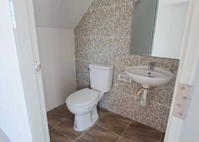 Small bathroom with tiled walls