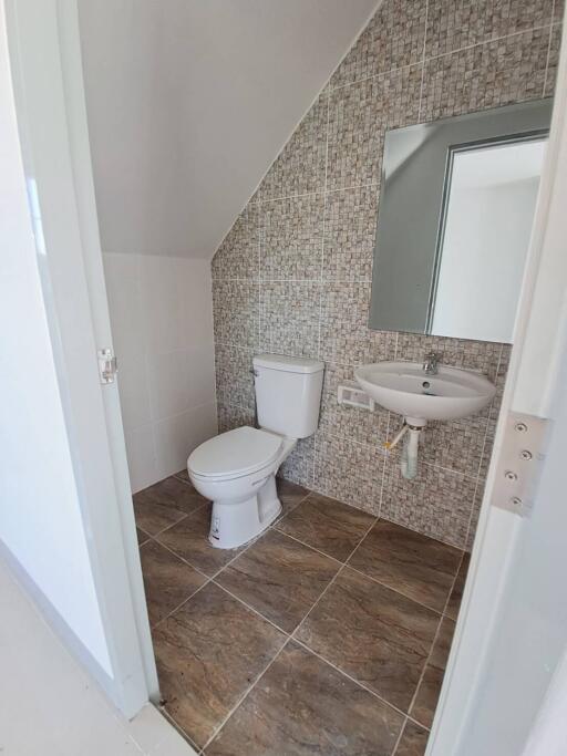 Small bathroom with tiled walls