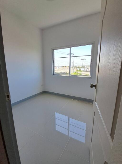 Bright empty bedroom with large window