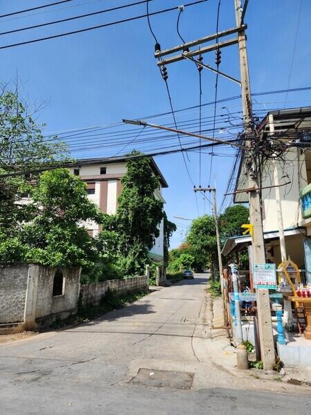 View of street with residential buildings and power lines