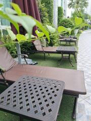 Outdoor lounge area with sunbeds and tables