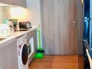 Modern kitchen with wooden flooring and appliances