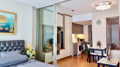 Modern bedroom with a view into the kitchen area