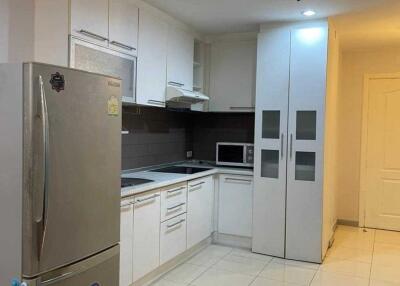 Modern kitchen with stainless steel appliances and white cabinetry