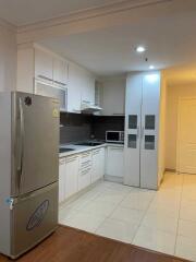 Modern kitchen with stainless steel appliances and white cabinetry