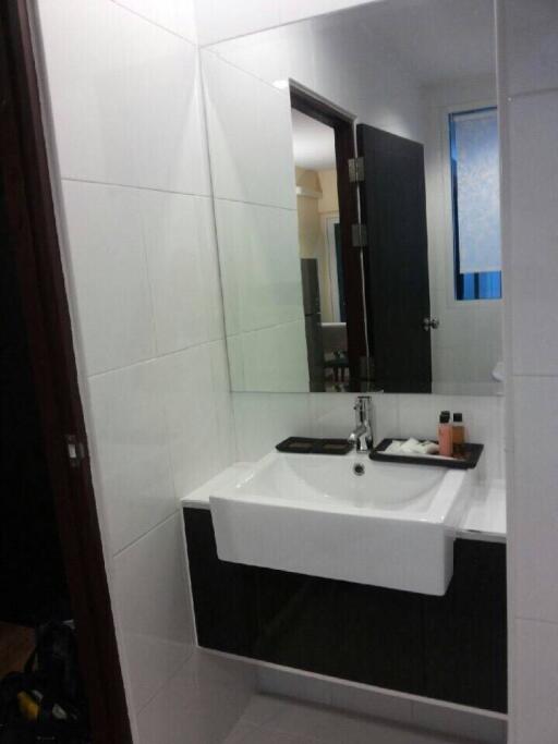 Compact modern bathroom with sink and mirror