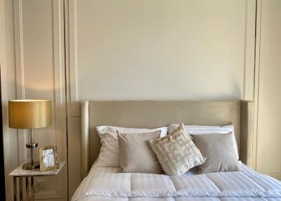 Well-decorated bedroom with modern bedside table and lamp