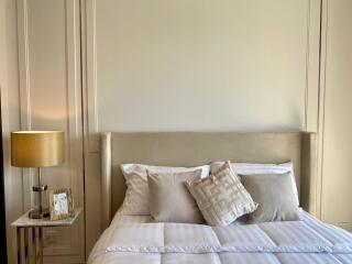 Well-decorated bedroom with modern bedside table and lamp