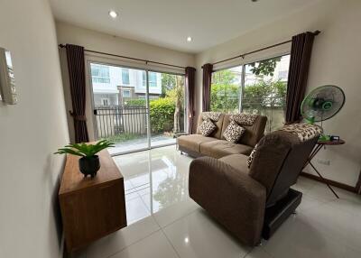 Cozy living room with large windows and garden view