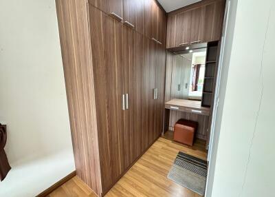 Bedroom with wooden wardrobes and dressing area