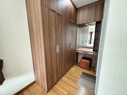 Bedroom with wooden wardrobes and dressing area